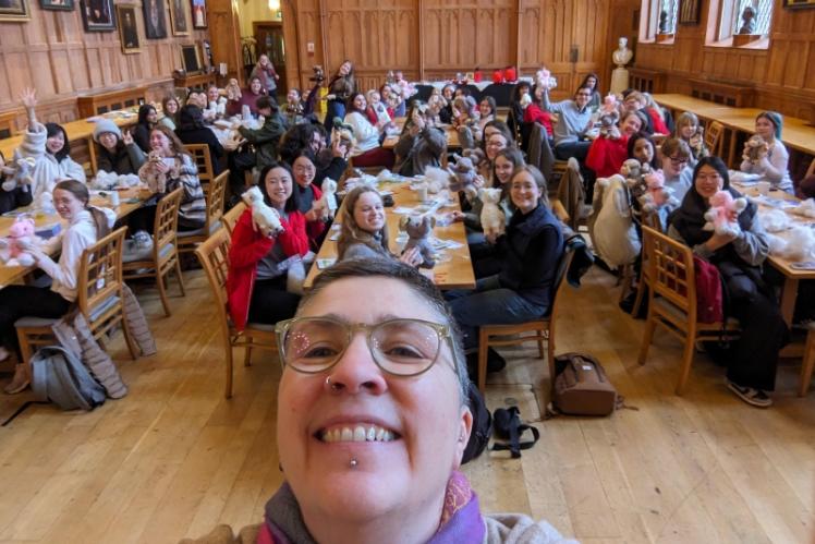 group photo of people smiling with teddy bears